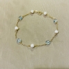 Bracciale in oro perle e topazio azzurro 